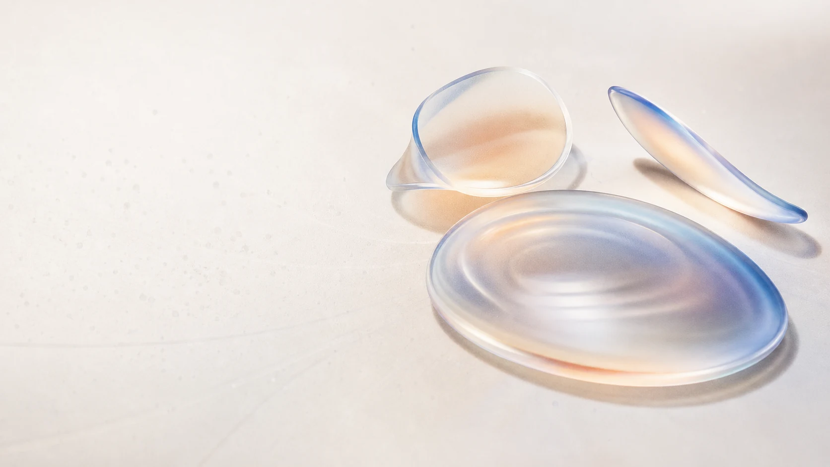 Translucent cobalt and apricot signal lenses arranged on a warm ivory field.